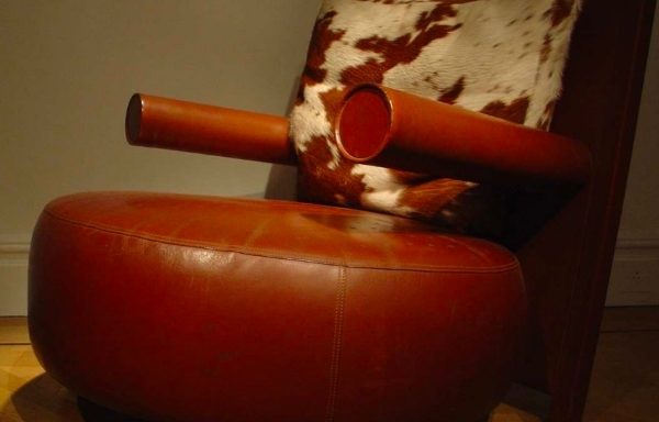 A pair of leather and cow hide chairs