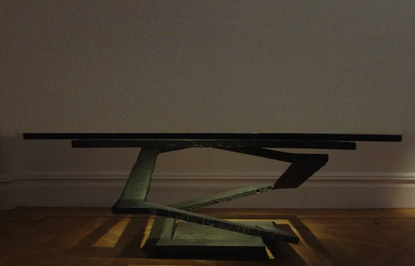 Cast metal center table with glass top